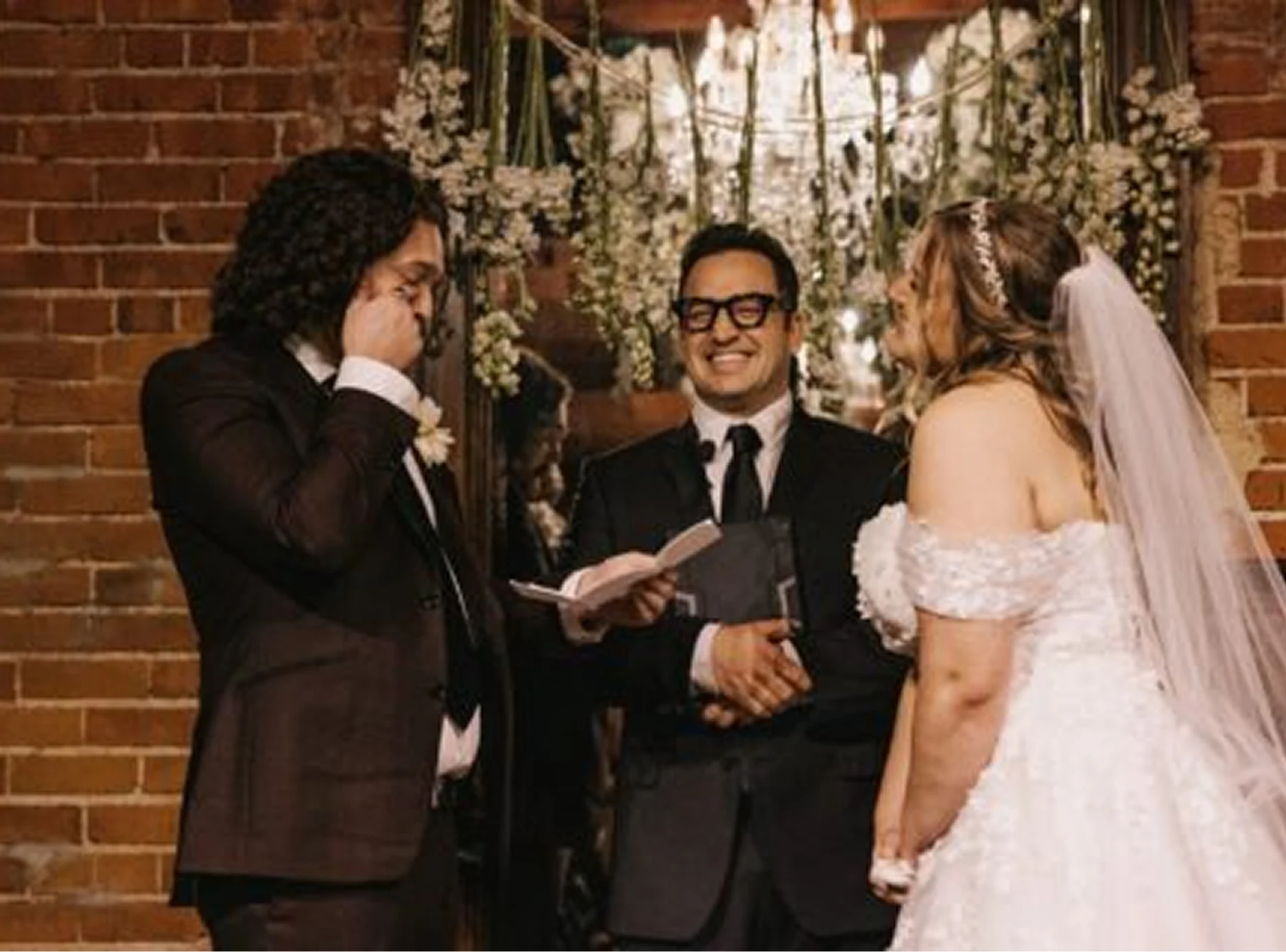 A couple standing in front of the officiant