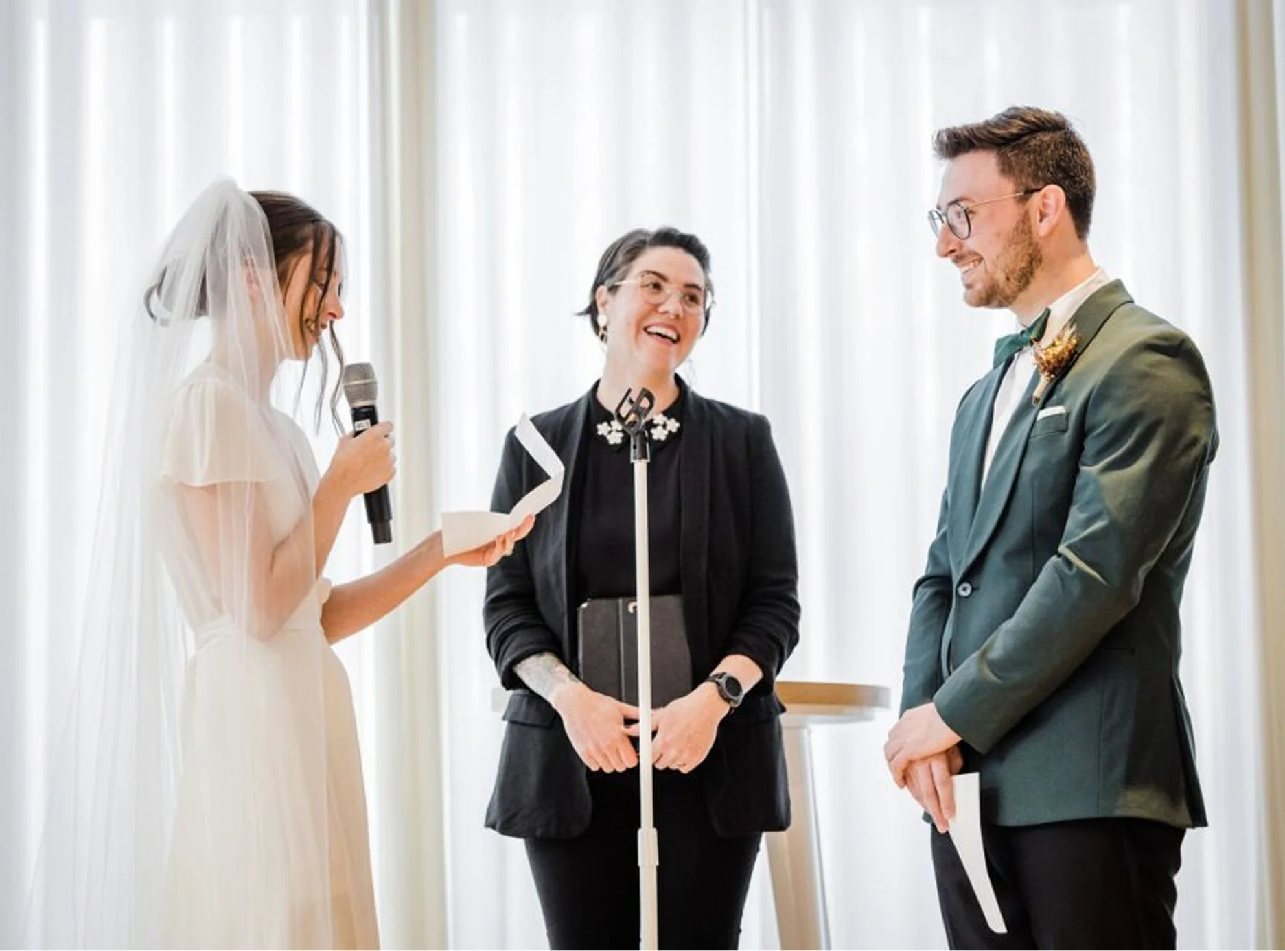 A couple standing in front of the officiant