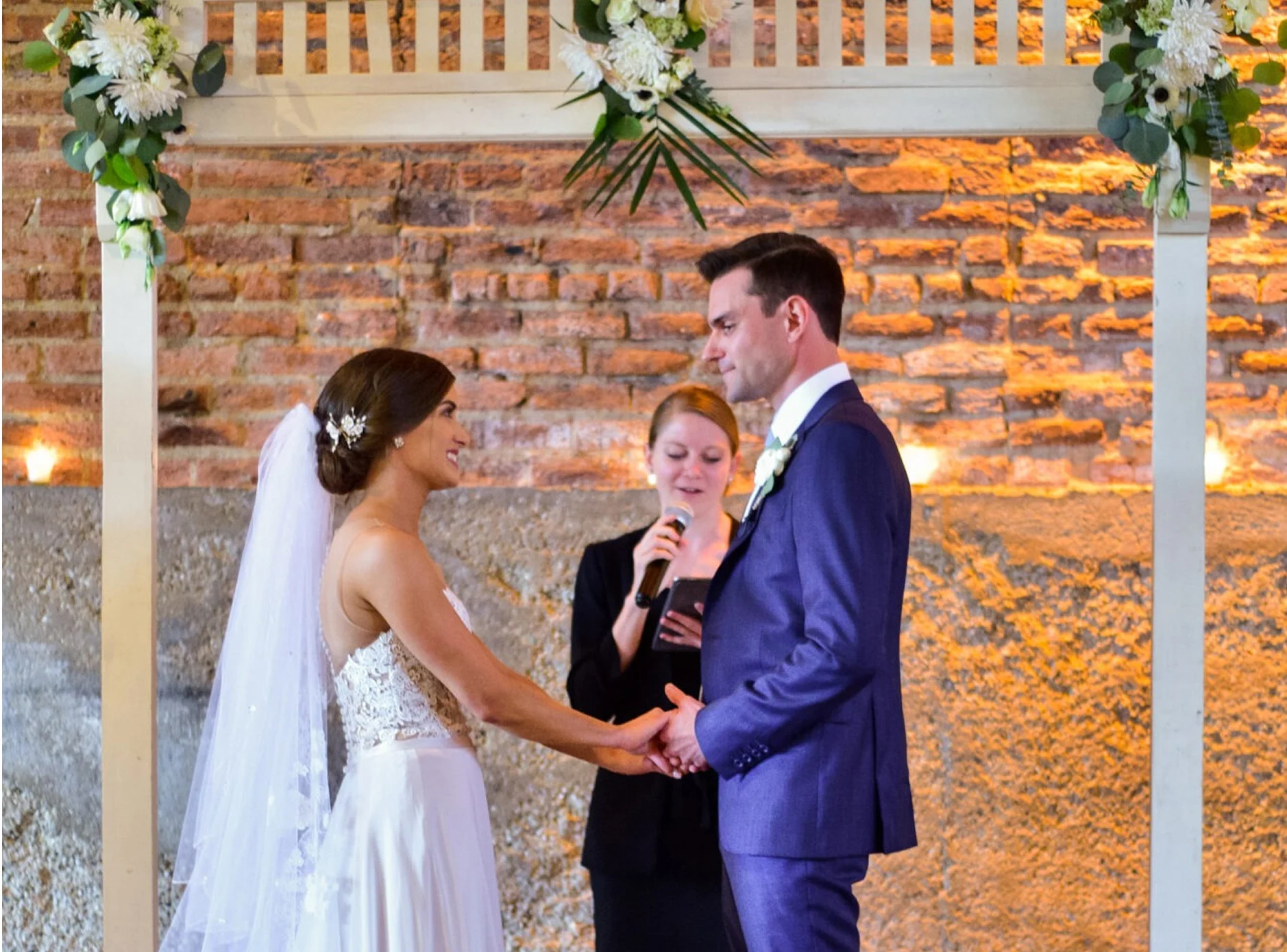A couple standing in front of the officiant