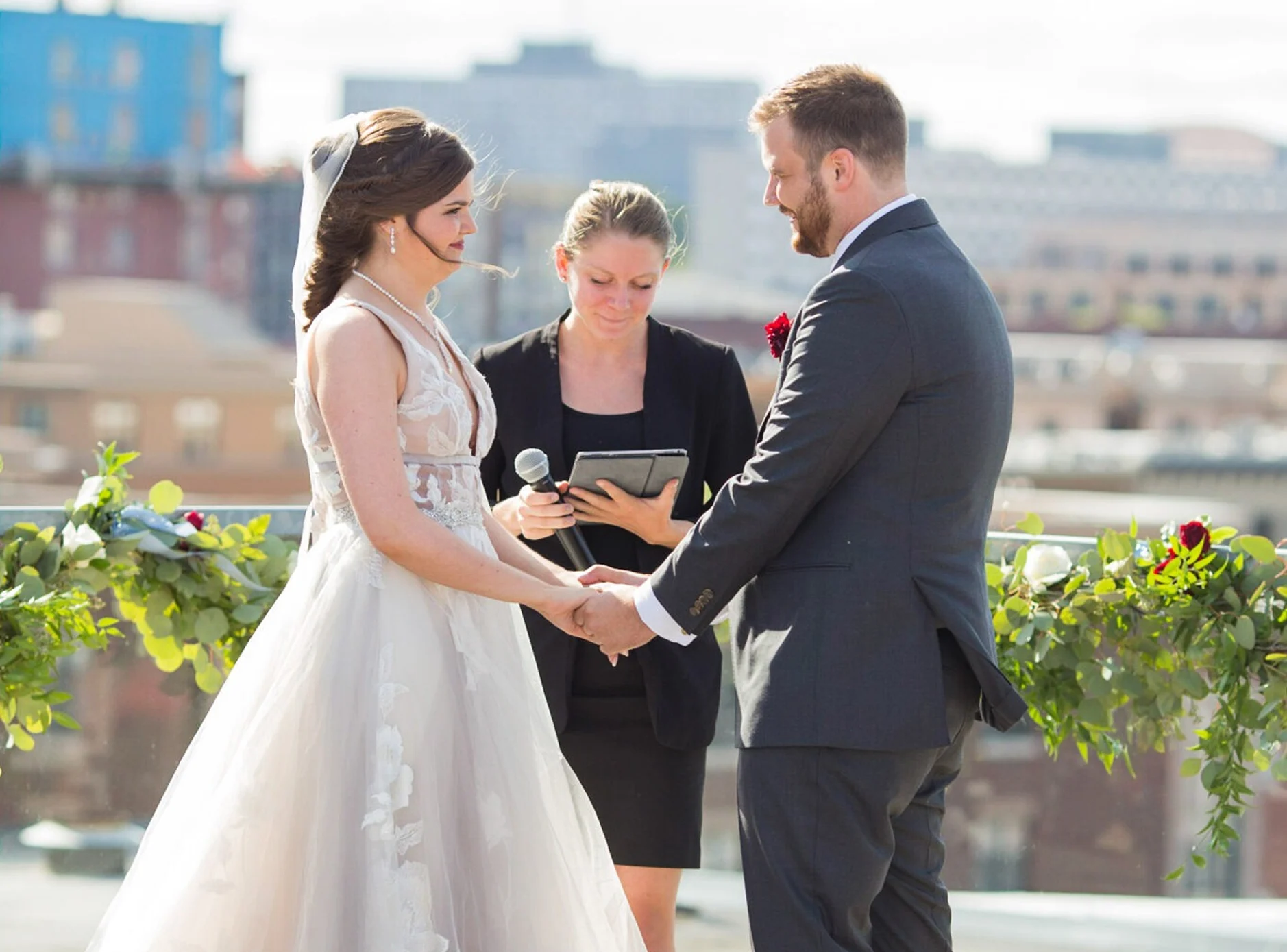 A couple standing in front of the officiant