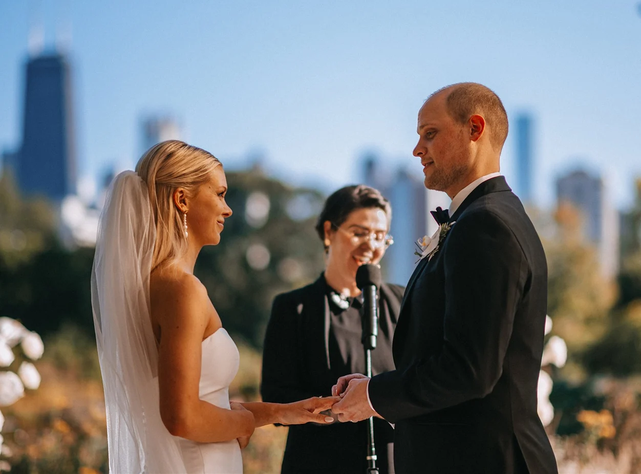 A couple standing in front of the officiant