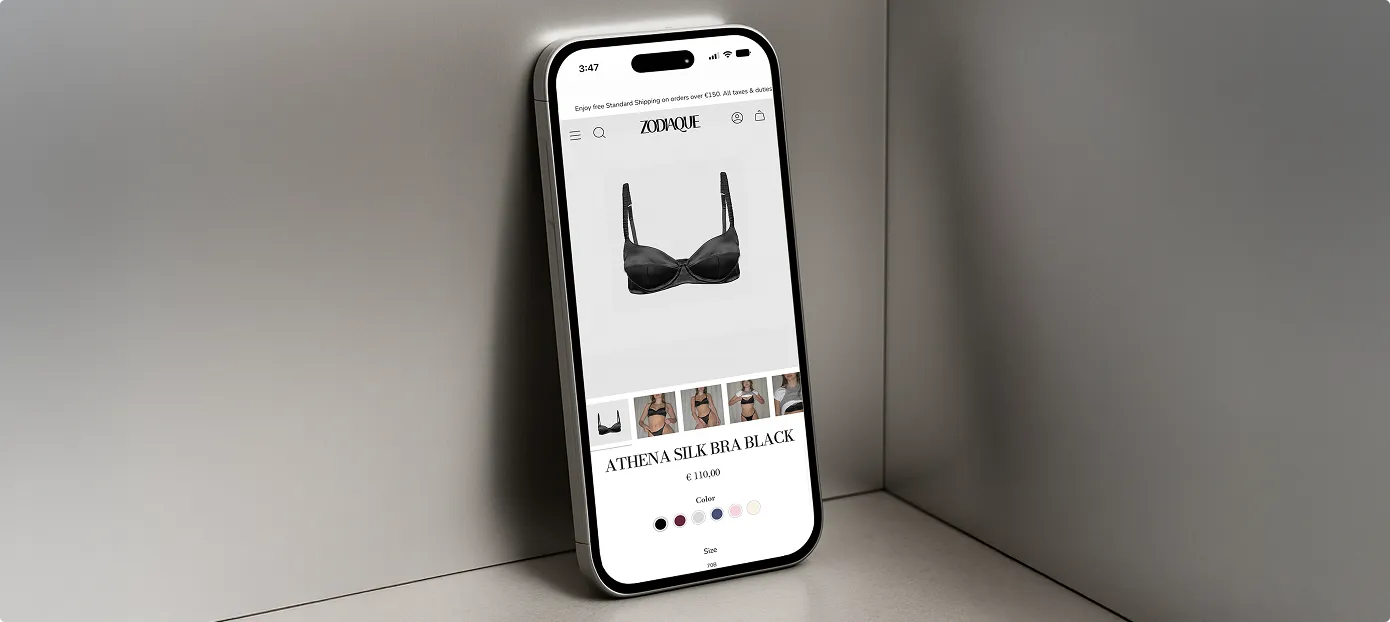 Smartphone zeigt eine Produktseite für einen schwarzen Athena Silk BH auf der Website Zodiaque.