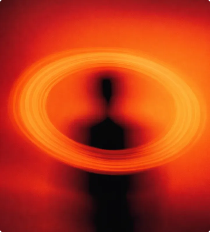 Person in schwarzer Silhouette mit einem leuchtenden, kreisförmigen Lichtkranz um den Kopf vor orange-rotem Hintergrund.