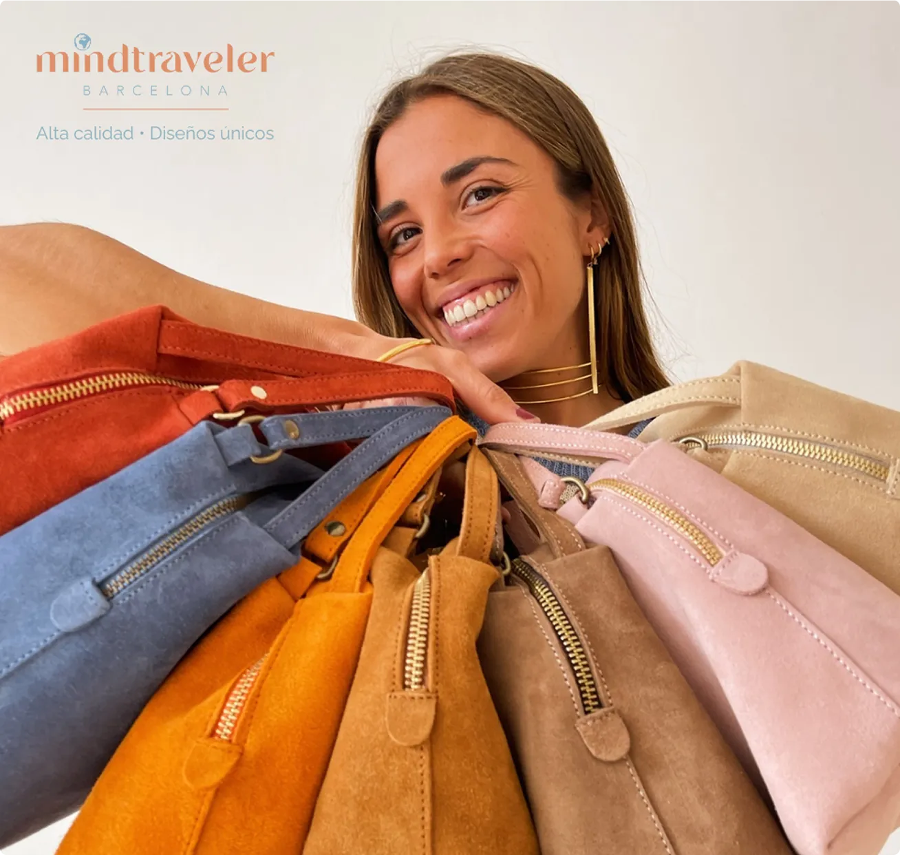 Mindtraveler Showcase: Smiling woman holding a selection of colorful suede bags in orange, blue, beige, pink and brown.