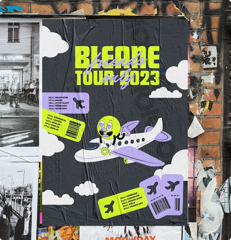 Poster on a brick wall showing a cartoon character with heart eyes flying a purple and white airplane surrounded by clouds and dates for the 'BLEACHED TOUR 2023' in yellow and lavender text.