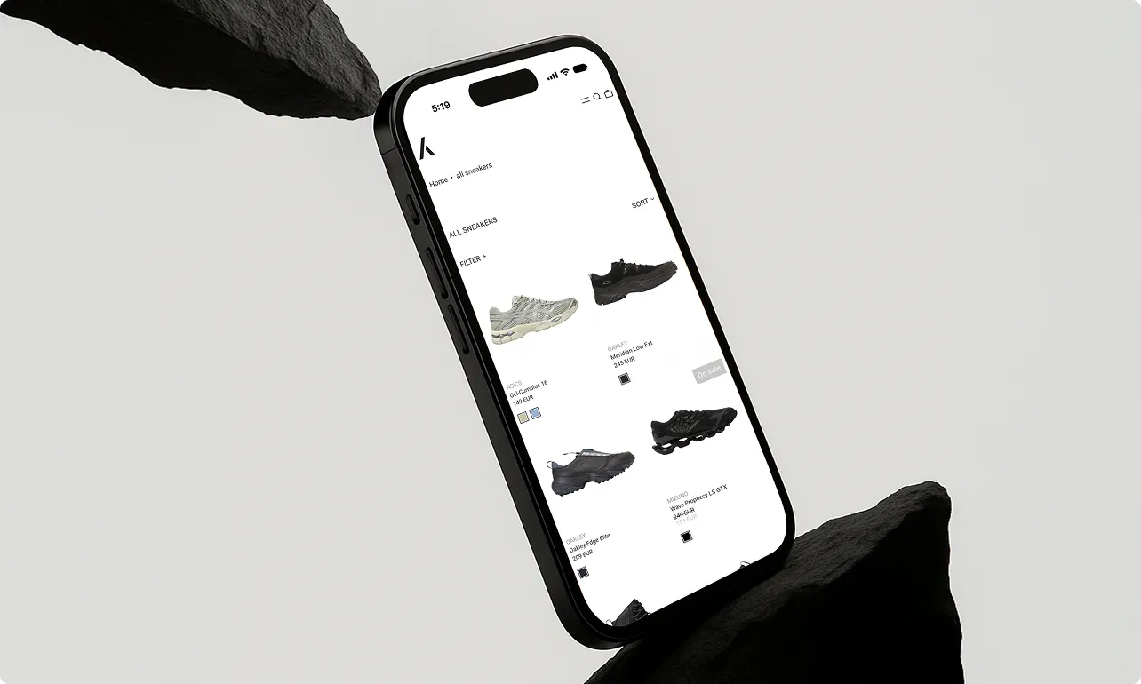 Smartphone zeigt Online-Shop-Seite mit verschiedenen Sneakers und Preisen.