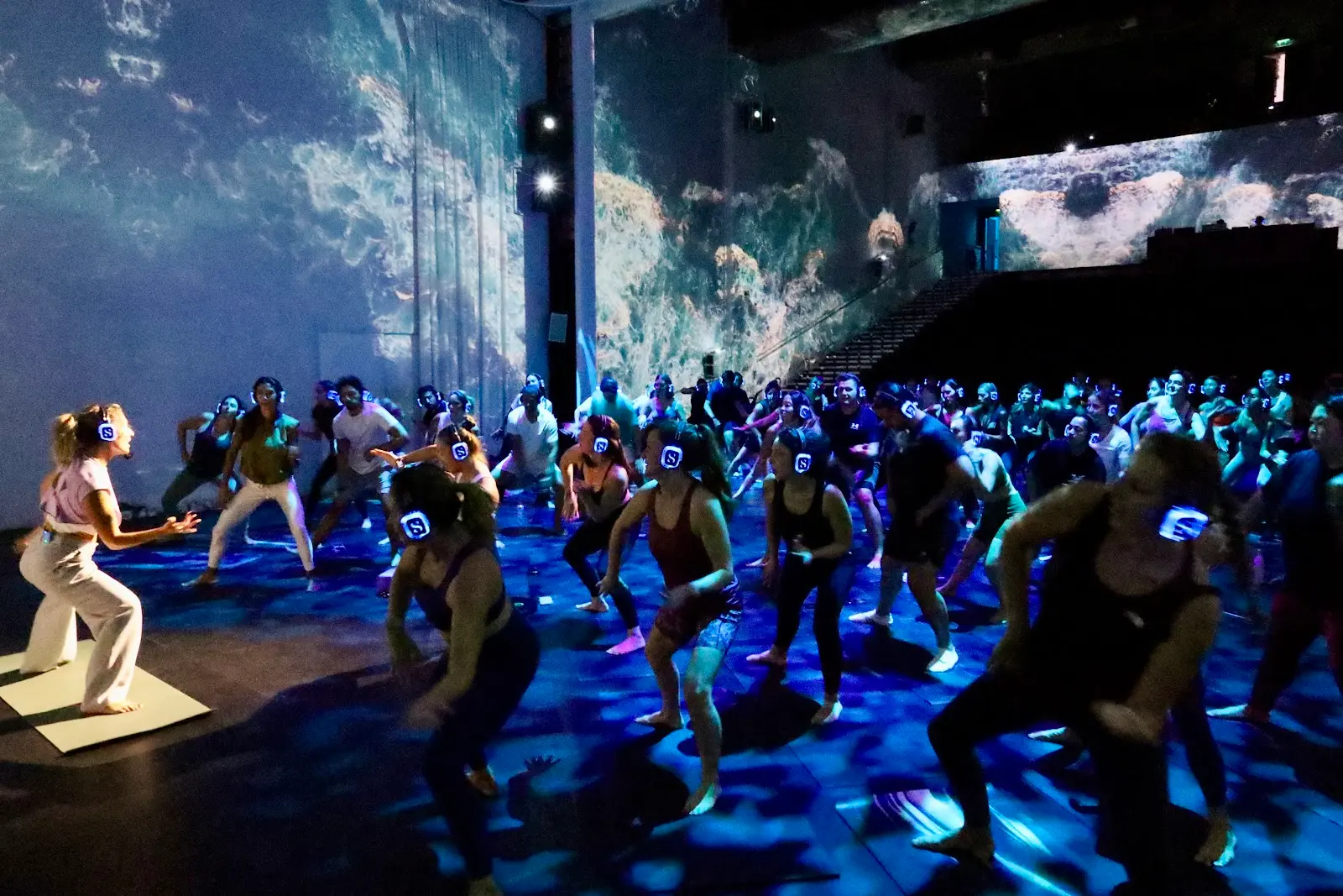 A full room moving beneath immersive projections at TODA