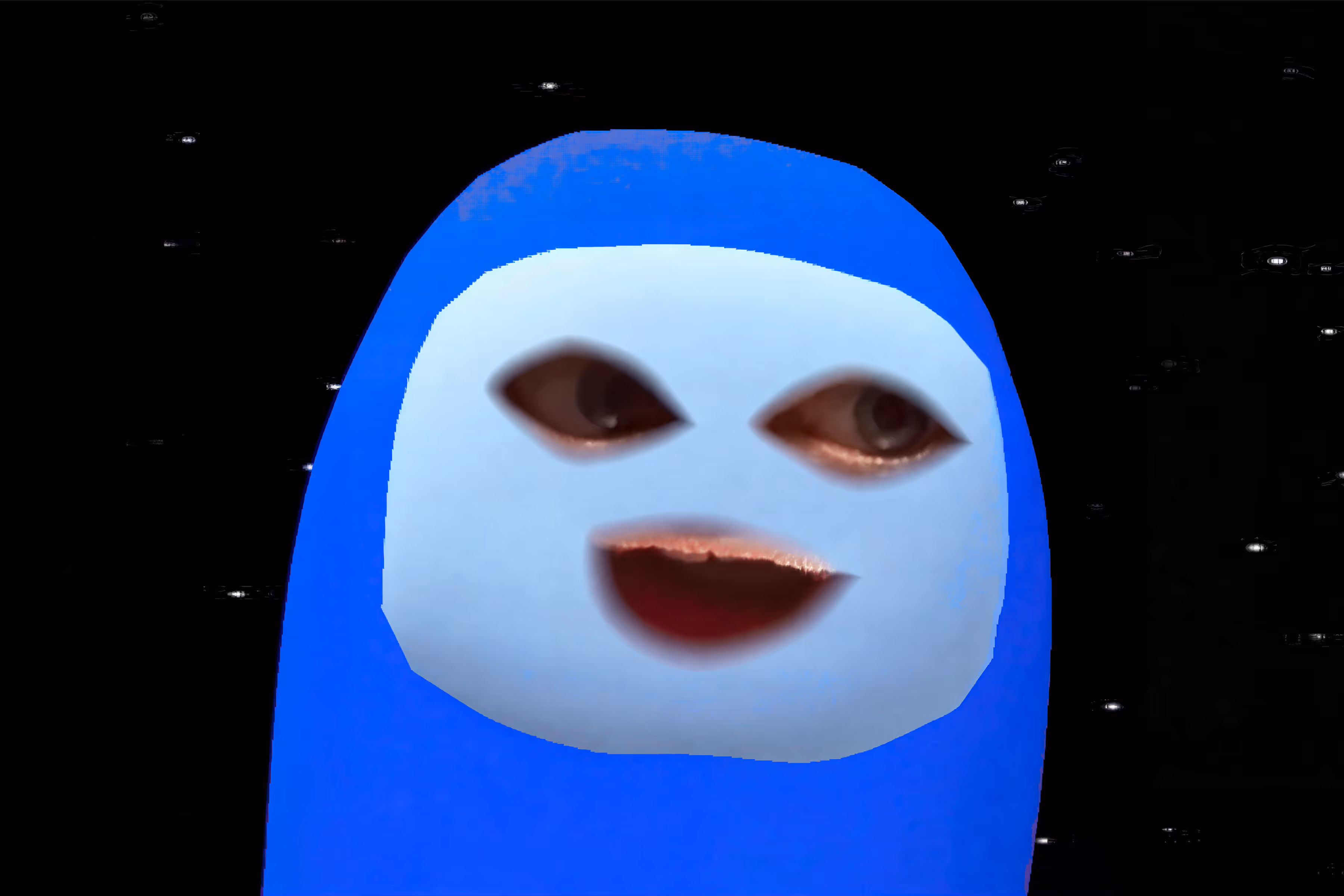 Blue Among Us character with a human face showing eyes and an open mouth on a black starry background.