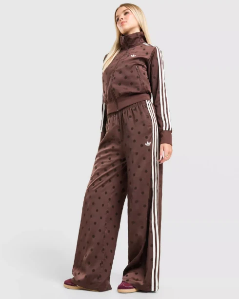 Model wearing a brown polka-dot tracksuit with cream stripes
