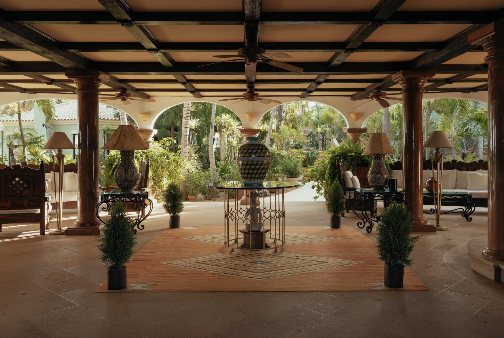 hotel lobby with ambient lighting, oriental rug, and symmetrical high-end decor.