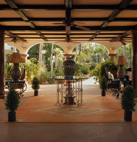 hotel lobby with ambient lighting, oriental rug, and symmetrical high-end decor.
