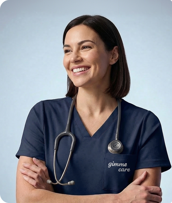 A female doctor smiling in blue scrubs