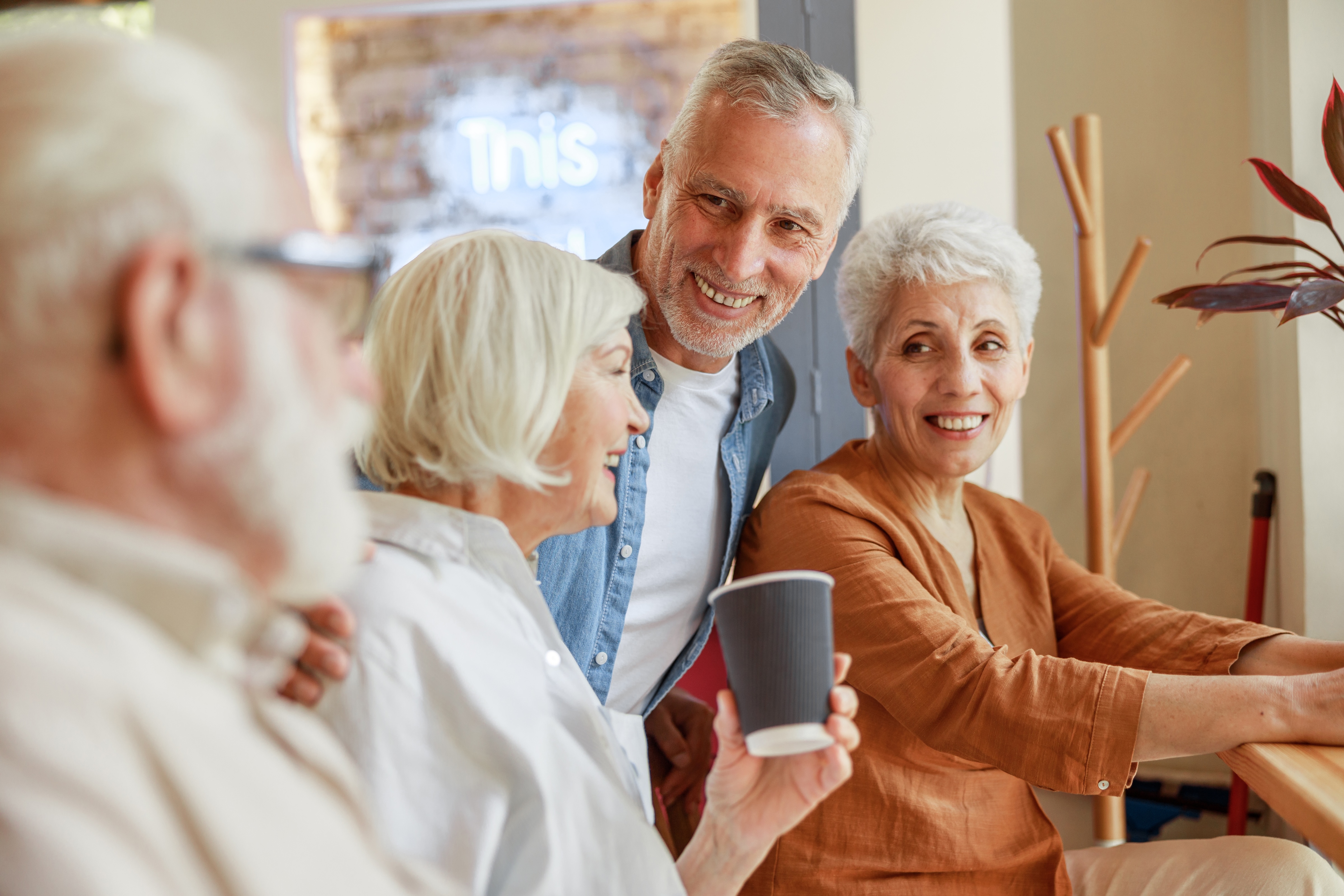 Senior men and women smiling at each other stock photo