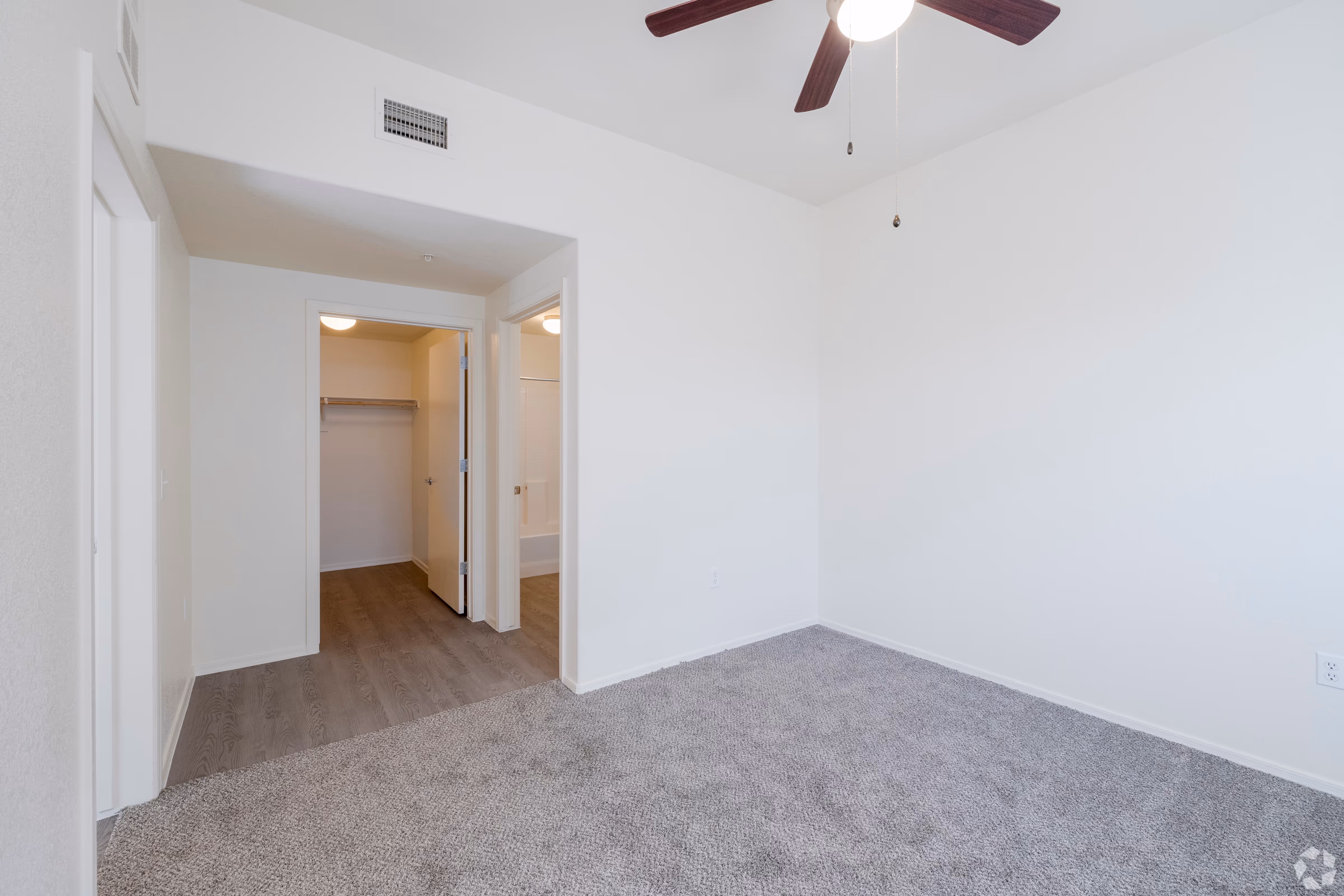 Empty bedroom with entrance to closet