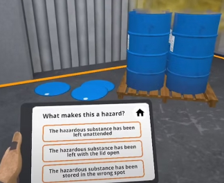 Person holding a tablet displaying a safety quiz about hazards near three blue barrels on a pallet in an industrial setting.