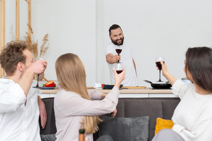 A cheerful gathering of people clinking wine glasses, sharing a moment of joy and togetherness during a celebration.