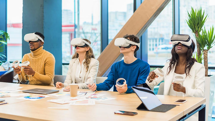 A group of five people at a conference table, all wearing virtual reality headsets, immersed in a collaborative experience.