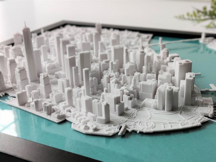 A 3D model of a city displayed within a sleek frame, showcasing intricate buildings and urban design.