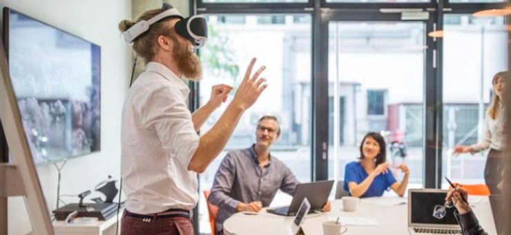 A suited man engages with a virtual reality device, illustrating the intersection of business and innovative technology.