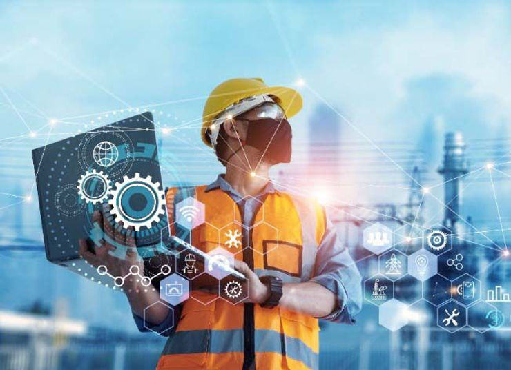 A man in a safety vest and hardhat is using a laptop, symbolizing the integration of safety and modern technology in the workplace.