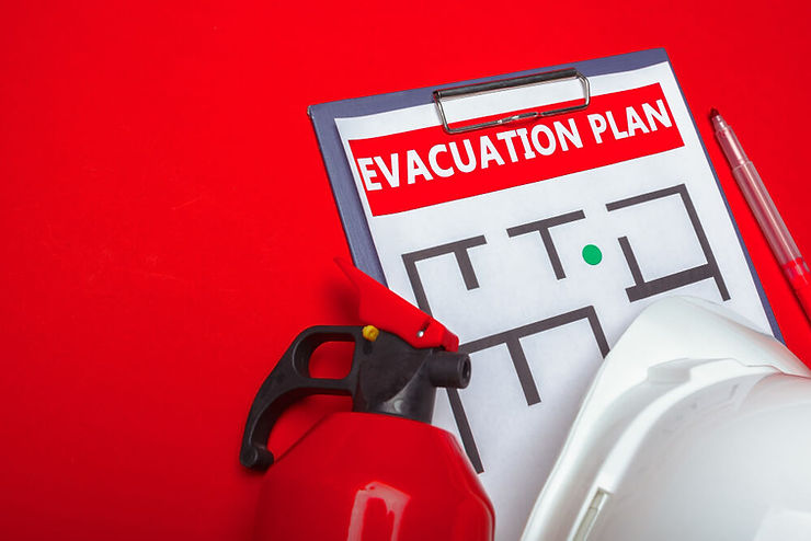 A fire extinguisher, fire helmet, and evacuation plan paper displayed on a red background, emphasizing fire safety equipment.