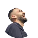 Man with short dark hair and beard, smiling and looking upward.