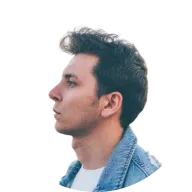 Profile of a young man with dark hair wearing a denim jacket and white shirt, looking to the left.