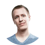 Young man with short light brown hair wearing a blue v-neck shirt, smiling slightly against a transparent background.
