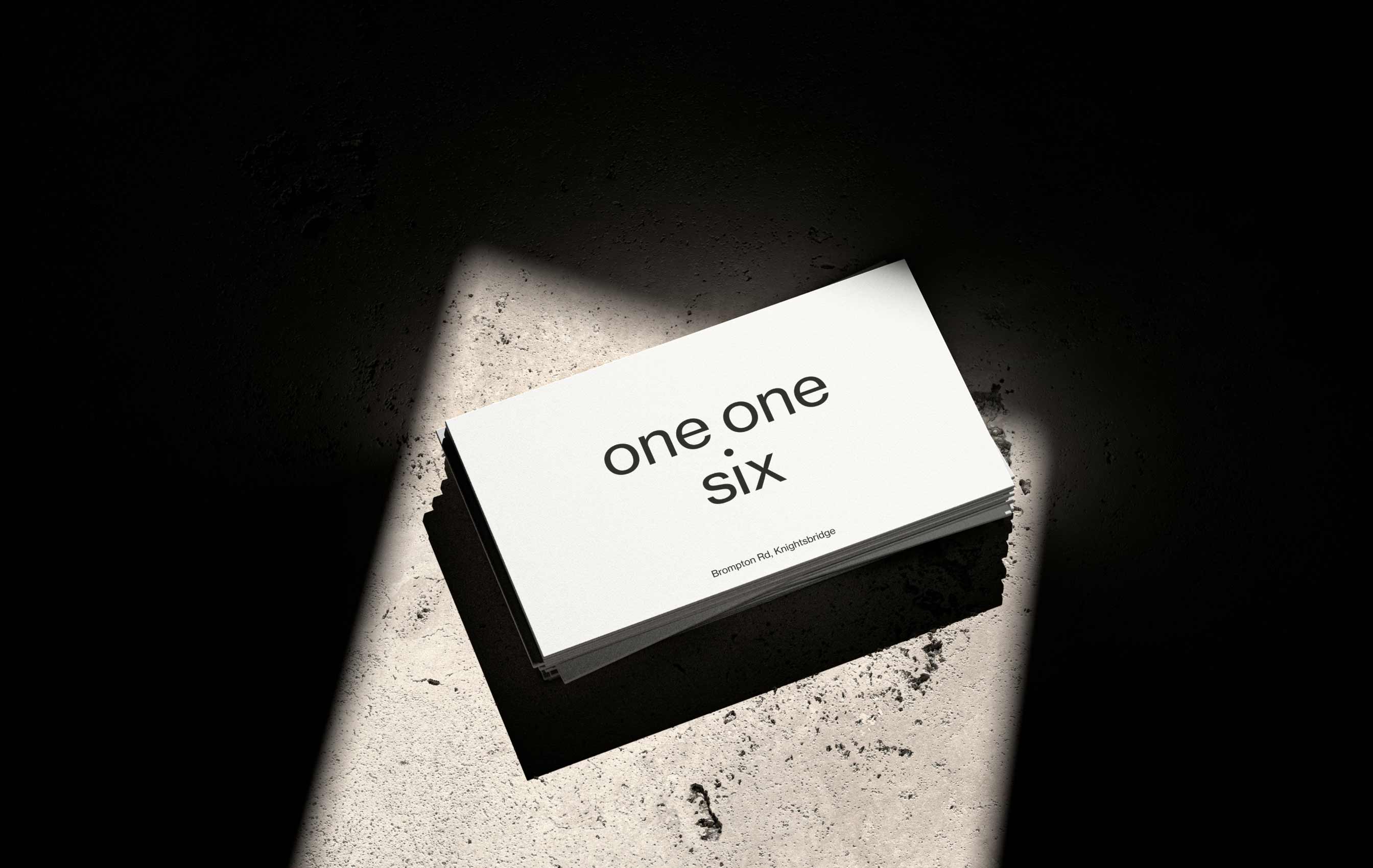 Stack of white cards on rough concrete floor.