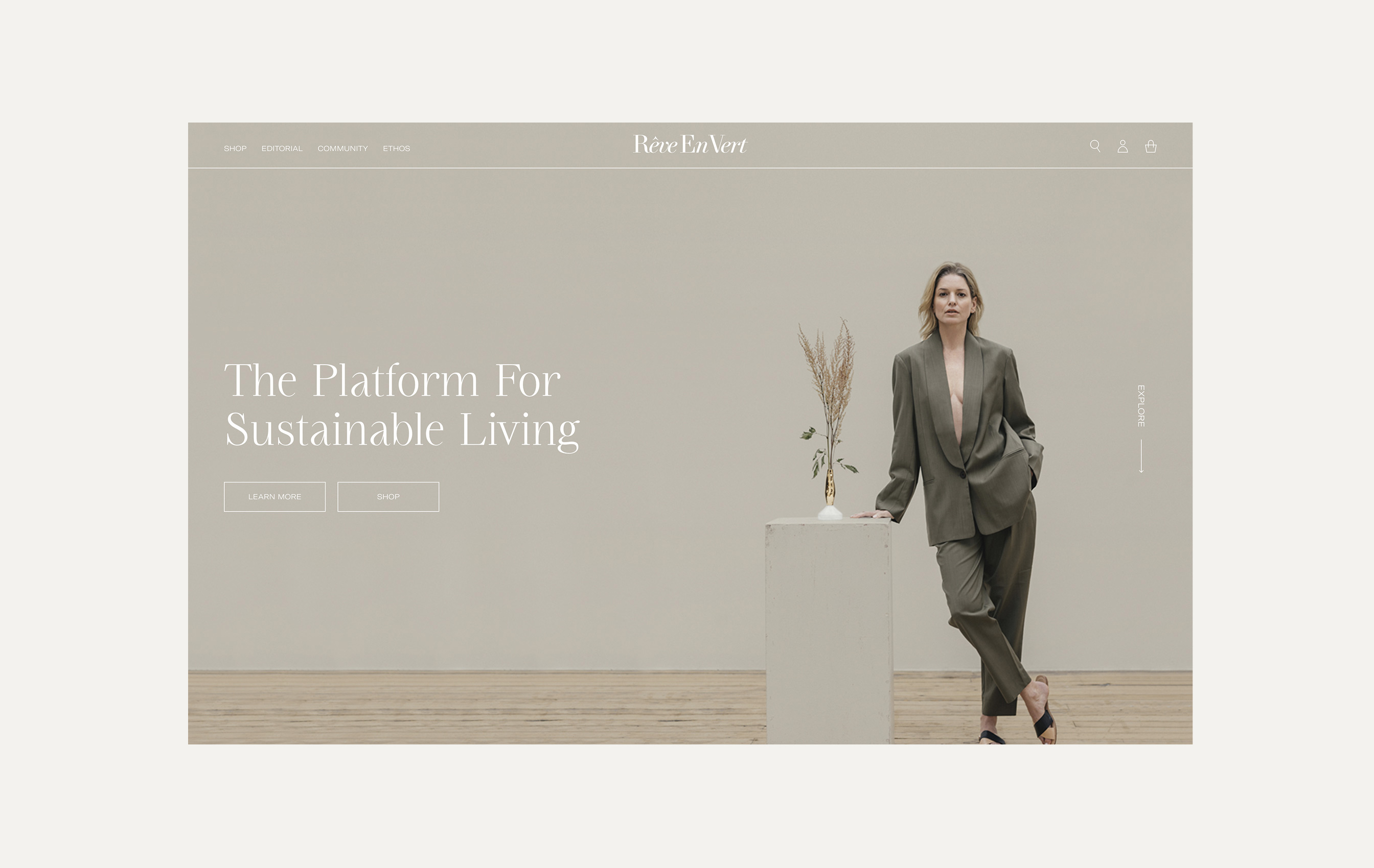 Woman in olive green suit leaning on a white pedestal with a vase of dried plants against a beige background with text reading The Platform For Sustainable Living.