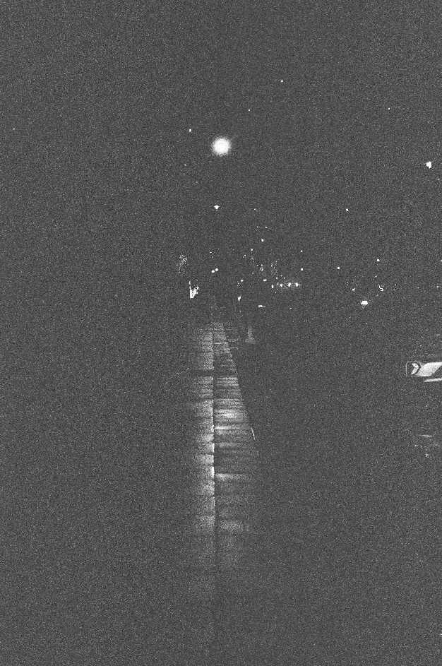 faded image of a sidewalk on a city street