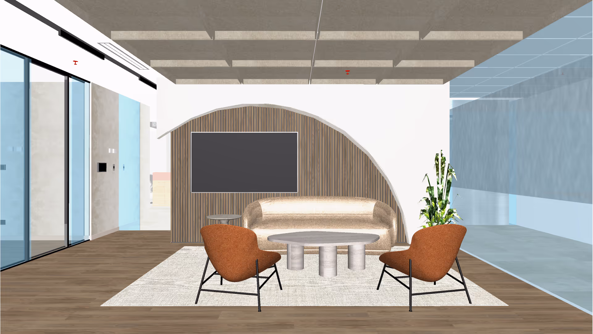 Oficina moderna con pasillo central, escritorios con separadores y plantas decorativas, y una persona caminando.