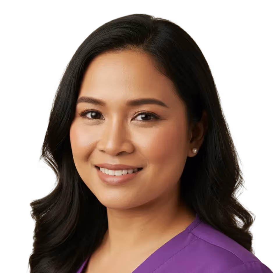 Smiling woman with long dark hair wearing a purple medical scrub top against a plain background.