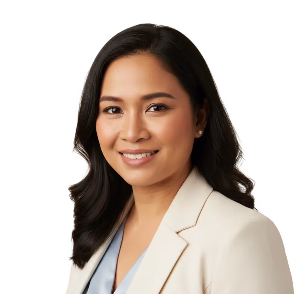 Smiling woman with long dark hair wearing a beige blazer and light blue top.