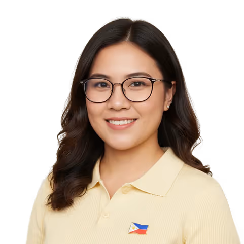 Smiling woman with glasses wearing a yellow polo shirt featuring a small Philippine flag pin.