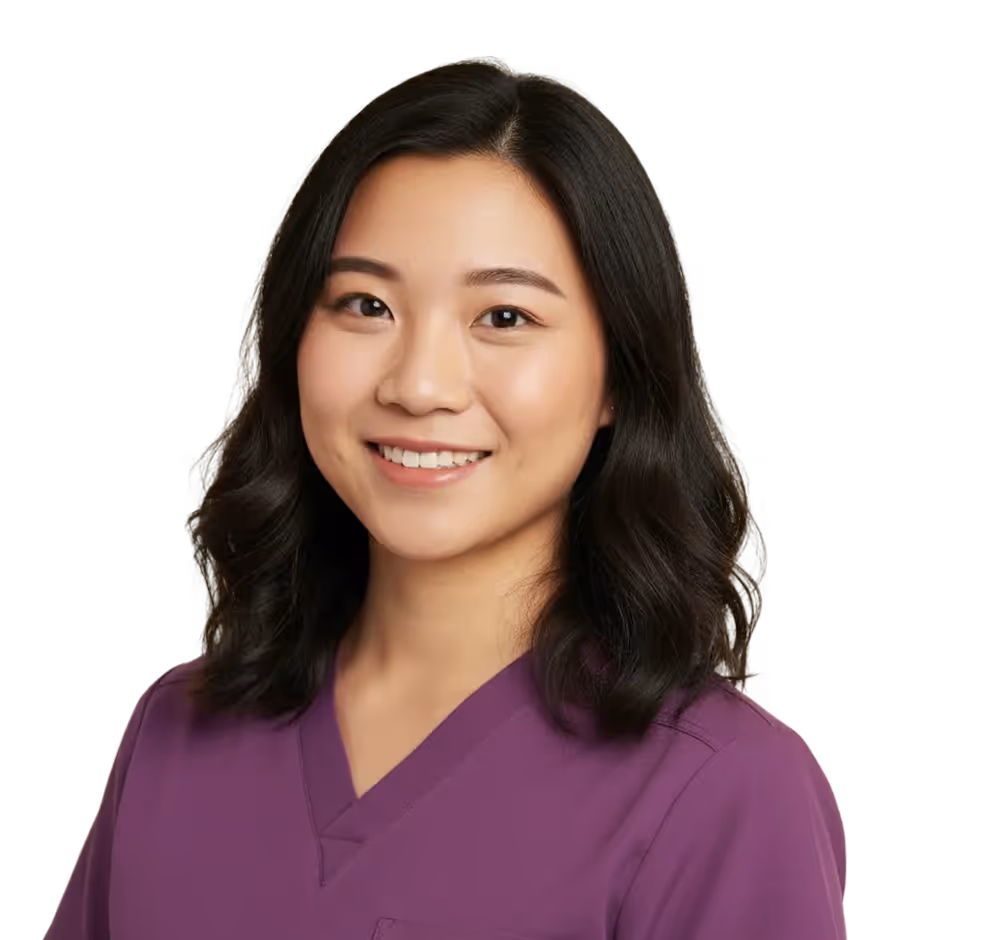 Smiling woman with shoulder-length black hair wearing a purple scrub top against a transparent background.