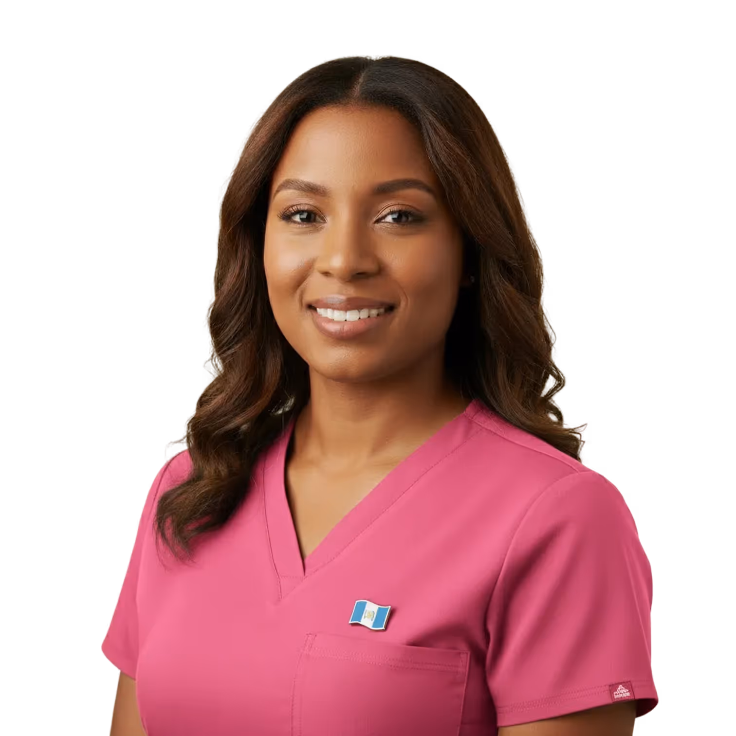 Smiling woman with wavy brown hair wearing a pink scrub top with a small flag pin on the chest pocket.