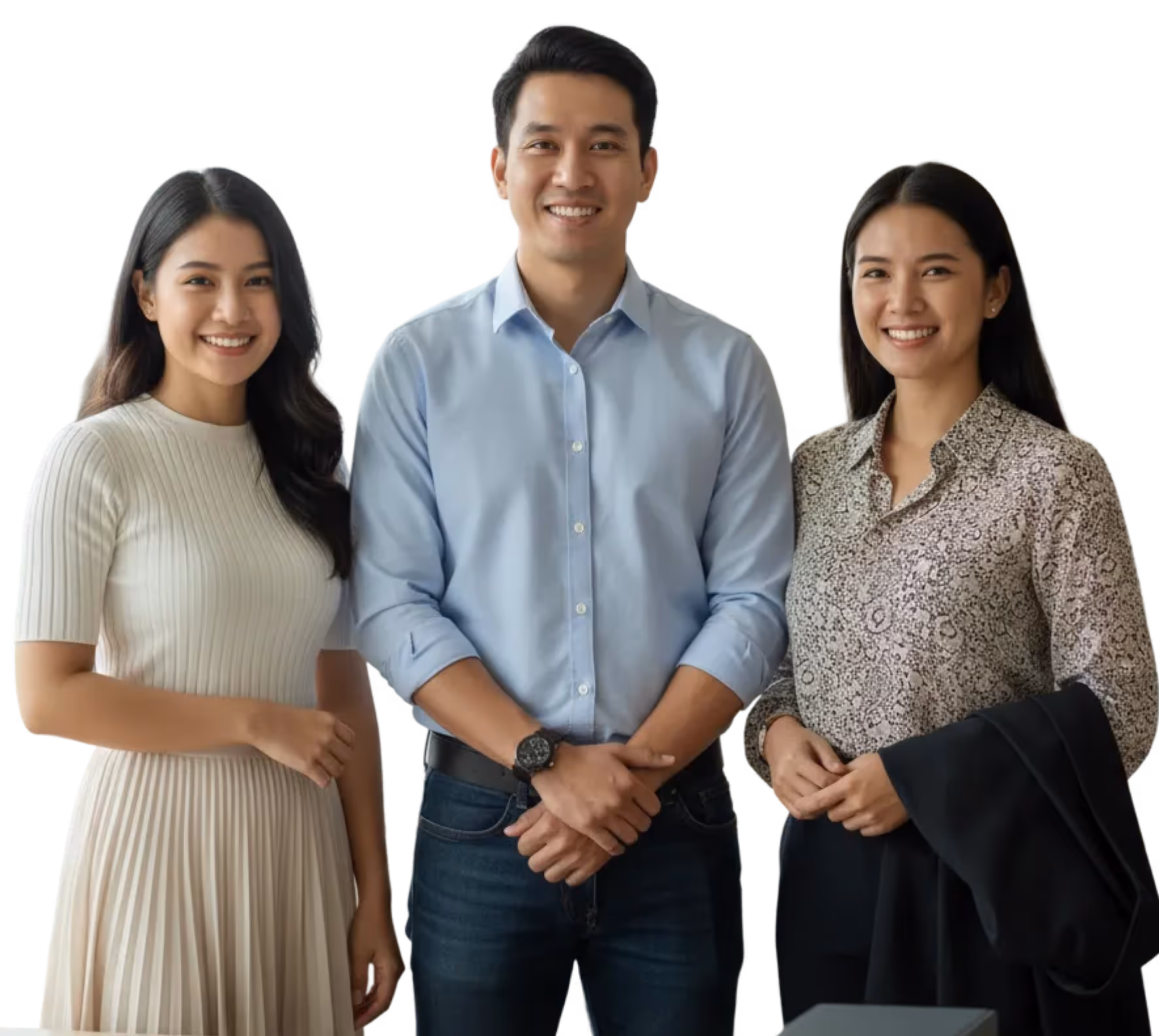 Three smiling young adults standing together, two women and one man in casual and business-casual attire.
