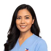 Smiling woman in blue scrubs with a Philippine flag pin on her chest.