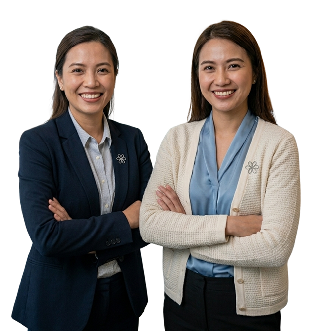 Two smiling professional women with crossed arms wearing business attire, one in a navy blazer and the other in a cream cardigan.