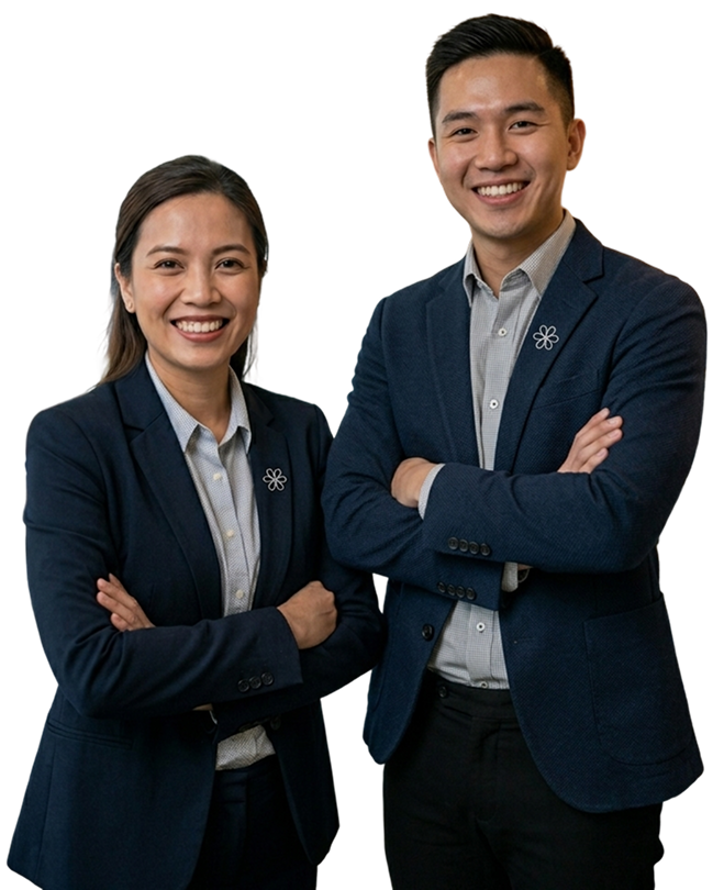 Smiling professional man and woman standing side by side with arms crossed, wearing navy blue blazers and light-colored shirts.
