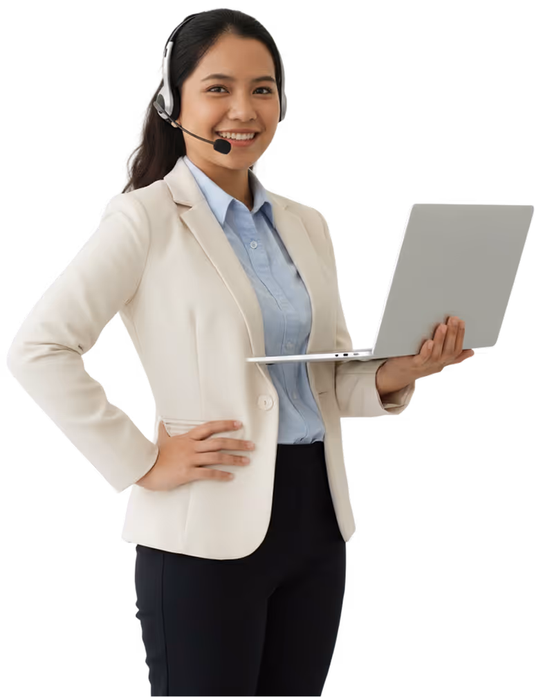 Smiling woman wearing a headset, holding a laptop, dressed in a beige blazer and blue shirt.
