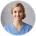 Smiling female healthcare professional in light blue scrubs with short blonde hair.