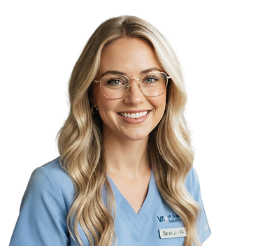 Smiling woman with long blonde hair and glasses wearing a light blue medical scrub top with a name tag that reads Sarah J. VA.