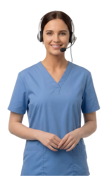 A smiling woman in blue medical scrubs wearing a headset with microphone, standing with hands clasped in front.