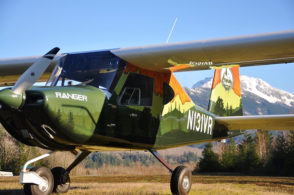 Vashon Ranger R7 parked on grass with a mountain backdrop