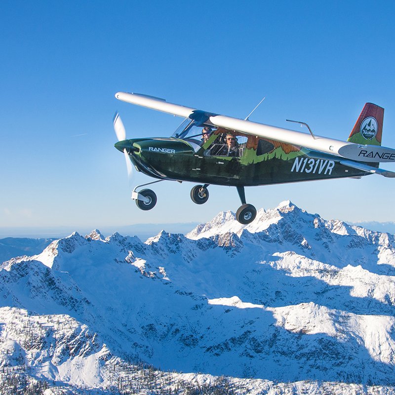 Vashon Ranger R7 flying above snow-capped mountain peaks.