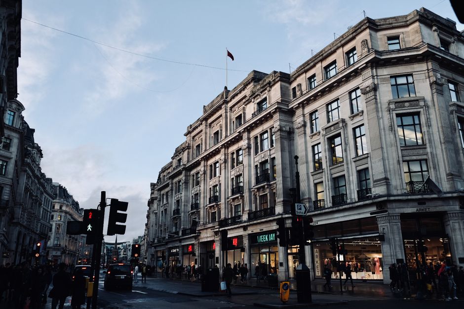 Street view of busy Oxford Street, London's famous shopping district, showcasing architecture and urban life.