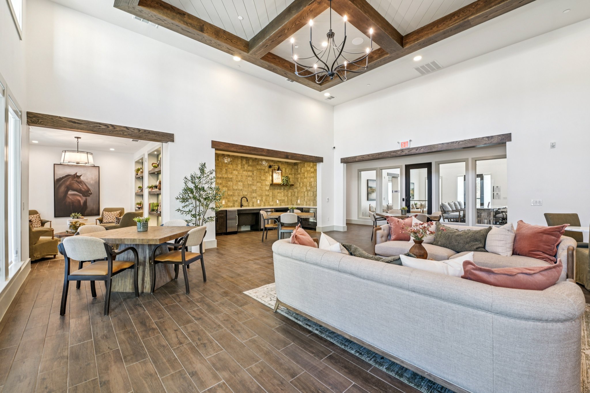 community lounge with sofa, tables, and chairs