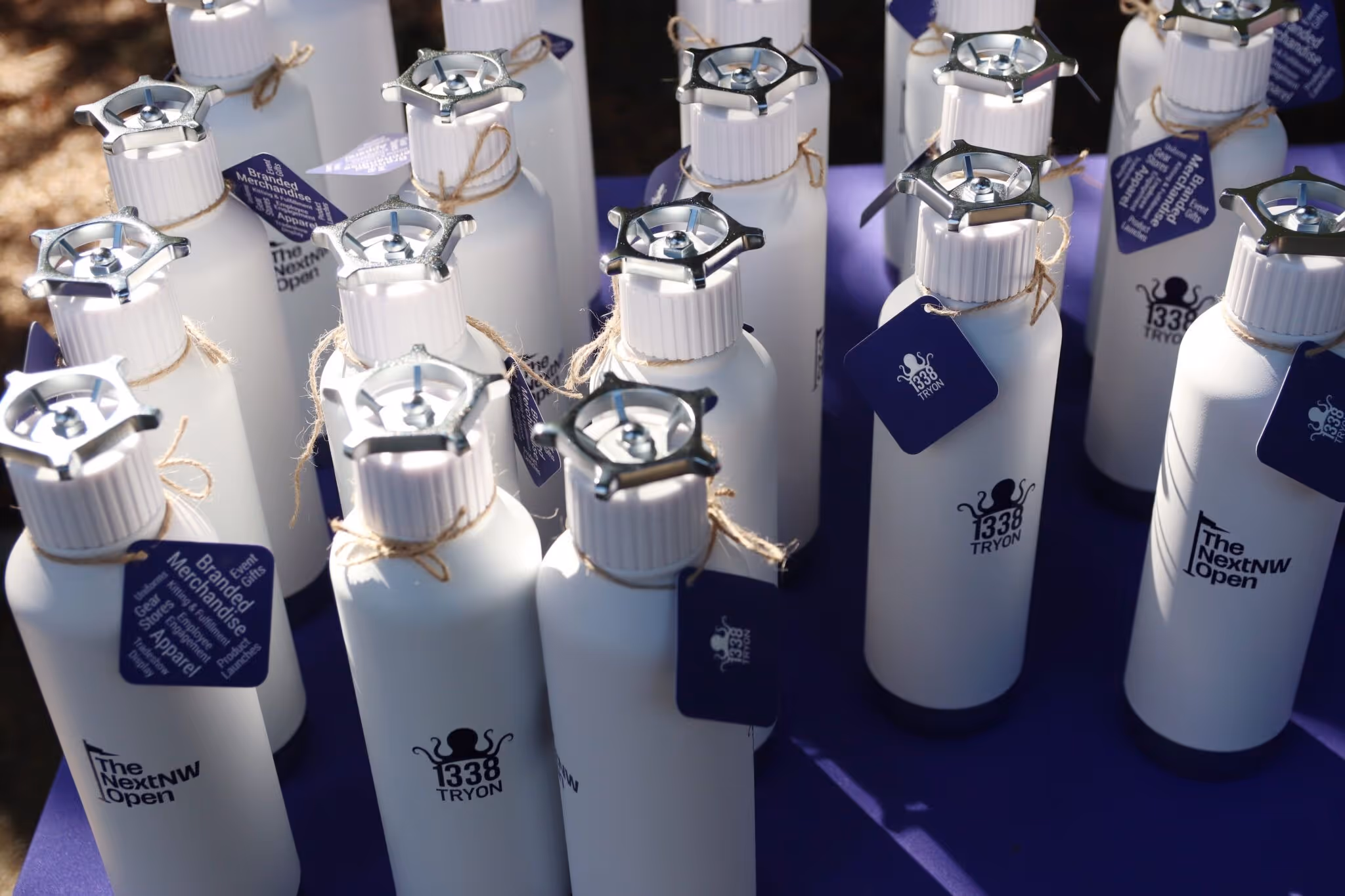 collection of branded water bottles at the golf tournament
